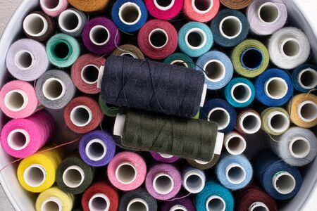 Lot of whole thread spools on white woodの写真素材