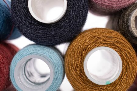 Lot of whole thread spools closeup isolated on whiteの写真素材