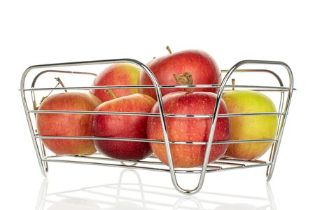 Group of five whole fresh garden apple in basket isolated on whiteの写真素材
