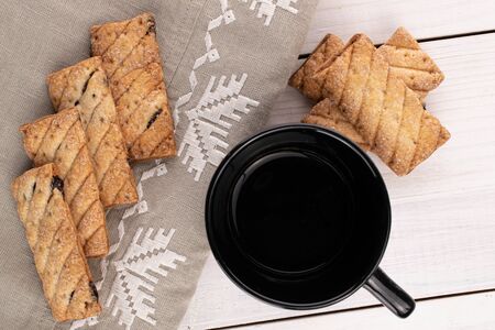 Lot of whole square puff cookie with raisins ready for breakfast on white wood