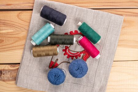 Lot of whole thread spool on linen on wood