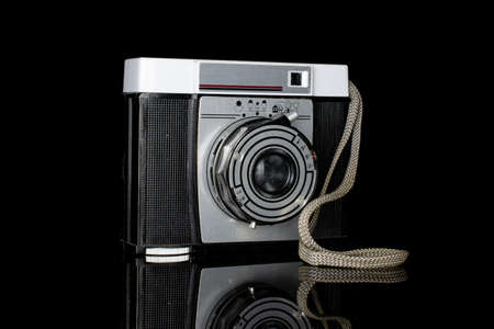 One whole vintage camera one lens isolated on black glassのeditorial素材
