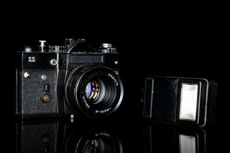 One whole camera with flash isolated on black glassのeditorial素材