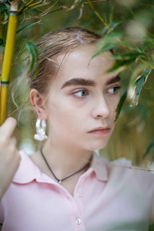 Woman with blonde hair portrait on the background of treesの写真素材