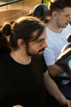 White european boys silhouettes through the windshield