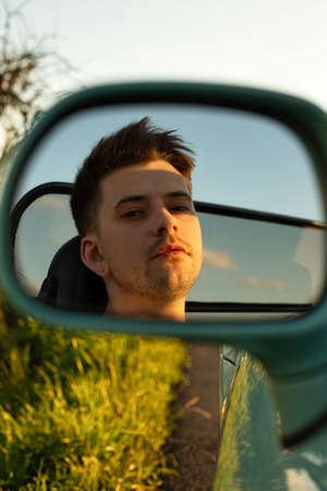 White young european model boy outside reflection in the mirror