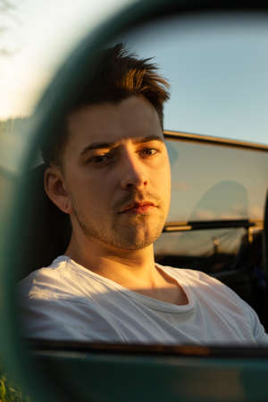 White young european model boy sitting outside reflection in the mirrorの写真素材