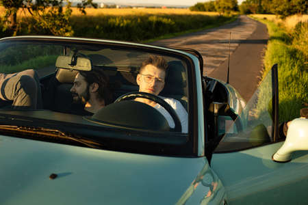 White european young boys sitting in the car outsideの写真素材