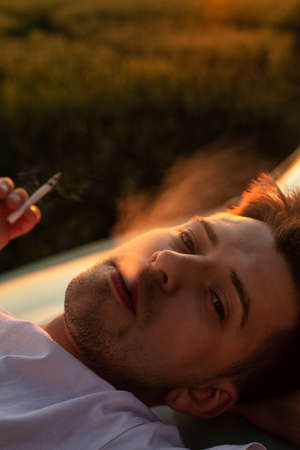 Smoking young white european boy with blonde hair