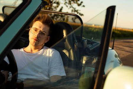 Young white european boy in the car driver