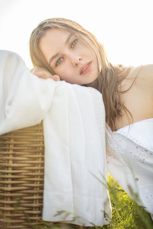 White young girl in white dress outside snuggling to laundryの写真素材
