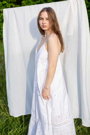 White girl model outside in front of the white sheetsの写真素材