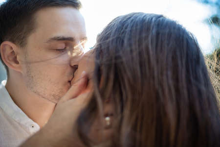 Kissing young white european couple portrait outside