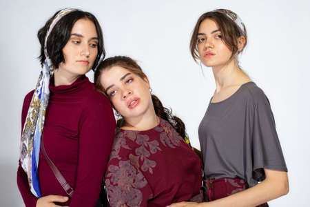 Three young white girls portrait on light greyの写真素材