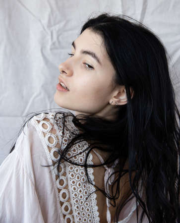 European white young girl portrait on white in a tunicの写真素材