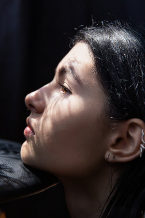 White european woman with dark hair portrait isolated on blackの写真素材