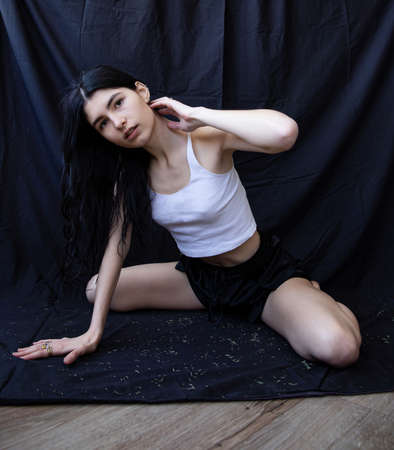 European white girl with hand near the face isolated on black