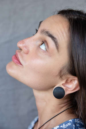 White european girl close-up portrait isolated on dark grey