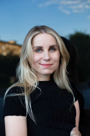 Smiling european white young woman portrait in black top