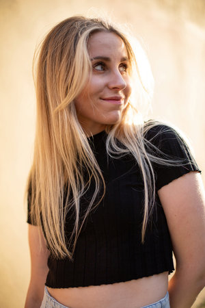 European white young girl portrait with blond hair near yellow wallの写真素材