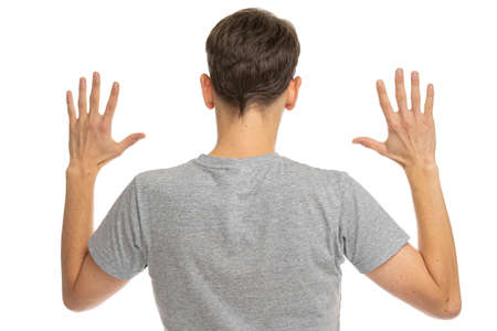 Young handsome tall slim white man with brown hair turned away from the camera showing his back and...