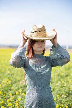 Young girl with dark hair in yellow blooming fieldの写真素材