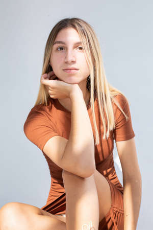 White girl with hand near the face isolated on greyの写真素材