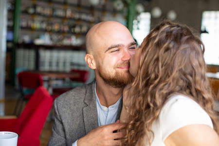 White young happy married couple sitting in the restaurantの写真素材