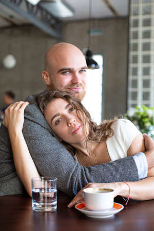 Young european married couple hugging in the restaurantの写真素材