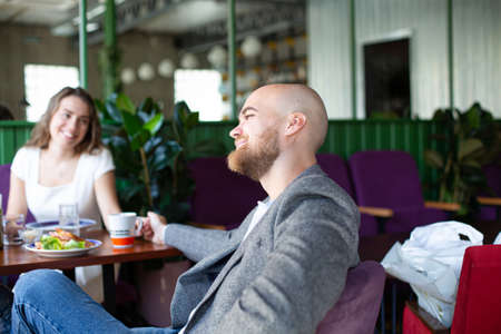 Happy white married couple sitting in the restaurantの写真素材