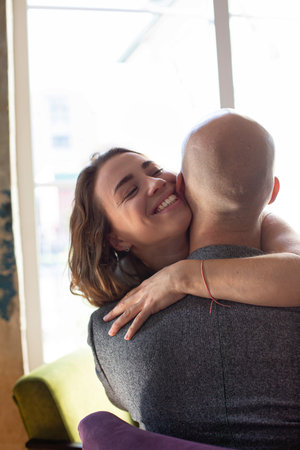 Happy white married couple hugging in the restaurantの写真素材