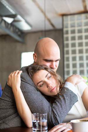Young european married couple hugging in the restaurantの写真素材