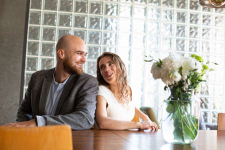 Young white married couple sitting in the restaurantの写真素材