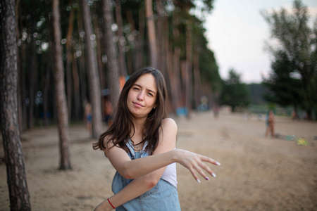 White european young girl with big lips with beach behind