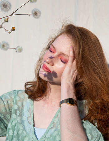 European girl with hand near the face portrait with closed eyes