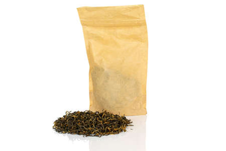 Dry black tea leaves with paper bag isolated on white backgroundの写真素材