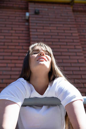 Smiling white european young girl with dark hair portraitの写真素材