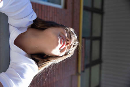 Smiling white european young girl with dark hair portraitの写真素材