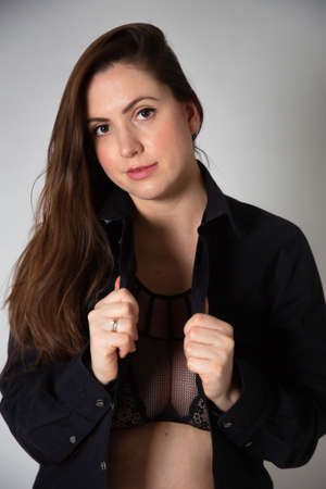 Portrait of young white european woman isolated on dark greyの写真素材