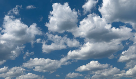 Bright blue sky with scattered white cumulus clouds during daylight