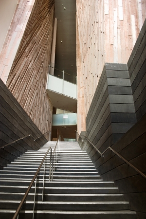 narrow stairs with handrails and wooden walls in modern architectureのeditorial素材