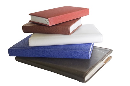 stack of notebooks in different colors and sizes isolated on the white