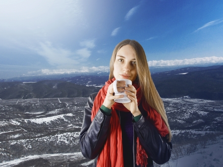 beautiful girl with a cup of tea on a winter landscapeの写真素材