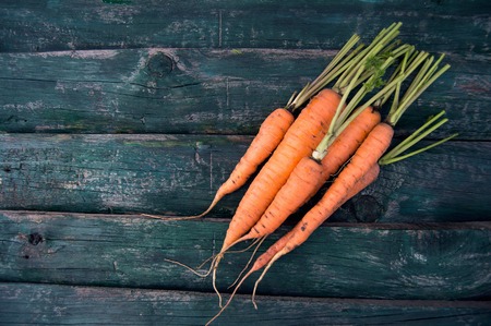 fresh farmer carrots on an old green wooden backgroundの写真素材