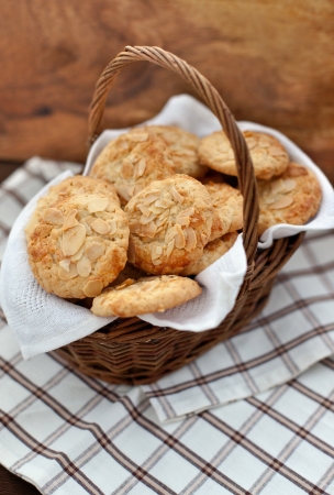 Oatmeal cookies with almond in a basket on a wooden backgroundの写真素材