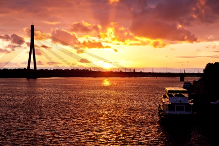 Sunset on the town river with bridge in Riga, Latviaの写真素材