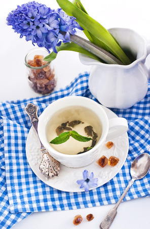 Cup of fresh herbal tea with mint on whiteの写真素材