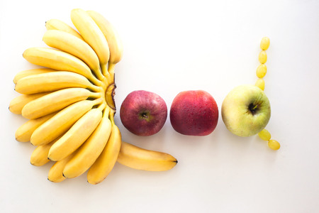 The word Good made from fresh fruits - banana and applesの写真素材