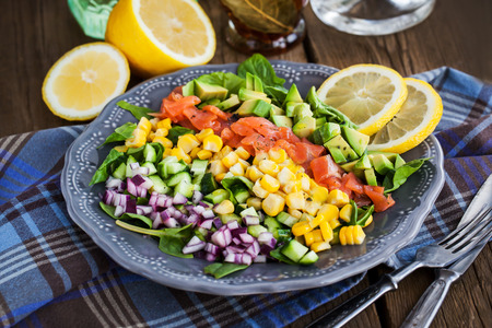 Delicious salmon, avocado, corn, cucumber and onion saladの写真素材
