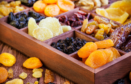 ?ssorted dried fruits in wooden printers box-figs, raisins, date, cranberries, currant, pears, ginger and apricotsの写真素材